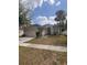 Charming single-story home features a two-car garage, palm tree and a well-maintained lawn at 1948 Bridgeview Cir, Orlando, FL 32824