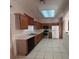 Functional kitchen equipped with stainless steel appliances, wood cabinets, and sleek countertops at 1948 Bridgeview Cir, Orlando, FL 32824