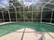 Outdoor pool offering privacy and views of the surrounding trees through a screen enclosure at 1948 Bridgeview Cir, Orlando, FL 32824