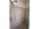 Tiled shower stall featuring a shower head and handheld sprayer attachment at 1948 Bridgeview Cir, Orlando, FL 32824