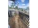 Weathered wooden balcony overlooking trees and other condo buildings at 228 Scottsdale Sq # 228, Winter Park, FL 32792