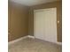 Bedroom features a double closet, tile flooring, and neutral walls at 228 Scottsdale Sq # 228, Winter Park, FL 32792