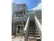 View of a two-story townhome with wooden balconies and staircase leading to the upper units at 228 Scottsdale Sq # 228, Winter Park, FL 32792