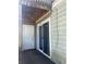 View of the sliding glass door and storage unit from the back patio area at 228 Scottsdale Sq # 228, Winter Park, FL 32792