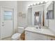 Well-lit bathroom with a single sink vanity, toilet, and decorative wall art at 2374 Eagle Trace Dr, Kissimmee, FL 34746