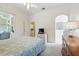 Bright bedroom with a queen bed, dresser, and sliding doors leading to the outdoor lanai at 2374 Eagle Trace Dr, Kissimmee, FL 34746