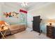 Cozy bedroom with unique wall art, a comfortable bed, and a convenient treadmill at 2374 Eagle Trace Dr, Kissimmee, FL 34746