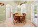 Bright breakfast nook with a wood table set, a window view and access to the lanai at 2374 Eagle Trace Dr, Kissimmee, FL 34746
