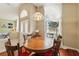 Traditional dining area with elegant lighting, wood floors, and easy access to the living space at 2374 Eagle Trace Dr, Kissimmee, FL 34746