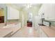 Kitchen featuring white cabinets, tile backsplash, and ample counter space at 2374 Eagle Trace Dr, Kissimmee, FL 34746