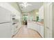 Kitchen with white appliances and cabinetry with an adjacent dining nook at 2374 Eagle Trace Dr, Kissimmee, FL 34746