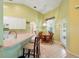 A view of the kitchen featuring white cabinets, a breakfast bar, and adjacent dining area at 2374 Eagle Trace Dr, Kissimmee, FL 34746