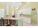 Kitchen with breakfast bar, white cabinetry and access to the living room at 2374 Eagle Trace Dr, Kissimmee, FL 34746