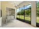 Enclosed lanai features a comfortable swing and views of the spacious backyard at 2374 Eagle Trace Dr, Kissimmee, FL 34746