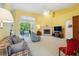 Bright living room with high ceilings, a fireplace, and sliding glass doors leading to the lanai at 2374 Eagle Trace Dr, Kissimmee, FL 34746