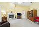 A spacious living room with a fireplace, entertainment center, and neutral carpet at 2374 Eagle Trace Dr, Kissimmee, FL 34746