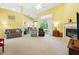 Open living room featuring neutral carpeting, fireplace and slider to screened porch at 2374 Eagle Trace Dr, Kissimmee, FL 34746