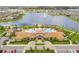 Aerial view of a resort-style community with a central lake, pool, clubhouse, and manicured landscaping at 2487 Empress Dr, Kissimmee, FL 34741