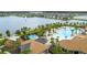 An aerial view of community pools, splash pad, palm trees, and a fountain in the distance at 2487 Empress Dr, Kissimmee, FL 34741