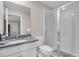 Bathroom featuring a granite countertop vanity and a walk-in shower at 2487 Empress Dr, Kissimmee, FL 34741