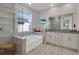 Modern bathroom features a soaking tub, glass shower, granite vanity and large window at 2487 Empress Dr, Kissimmee, FL 34741
