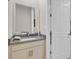 Half bathroom features a granite vanity with a large mirror and neutral paint at 2487 Empress Dr, Kissimmee, FL 34741