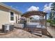 An outdoor deck features a pergola, seating, and nearby yard area at 2487 Empress Dr, Kissimmee, FL 34741