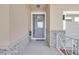 Covered porch with decorative front door with sidelights and stone wall accents at 2487 Empress Dr, Kissimmee, FL 34741