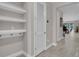 Hallway with storage shelves and a view into the living room at 2487 Empress Dr, Kissimmee, FL 34741