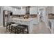 Bright kitchen boasts stainless steel appliances, granite counters, island with breakfast bar and stylish backsplash at 2487 Empress Dr, Kissimmee, FL 34741
