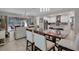 Open-concept living space with kitchen, dining area and view to outdoor screened lanai at 2487 Empress Dr, Kissimmee, FL 34741