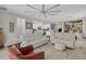 Open-concept living room showcases neutral colors, a unique ceiling fan, and tile flooring throughout at 2487 Empress Dr, Kissimmee, FL 34741