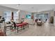 Open-concept living room with dining area, tile floors, and sliding glass doors to the lanai at 2487 Empress Dr, Kissimmee, FL 34741