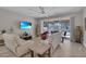 Bright living room has sliding glass doors providing access to the screened lanai and views of the backyard at 2487 Empress Dr, Kissimmee, FL 34741