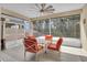 Covered patio features outdoor seating, a ceiling fan, and views of the surrounding trees at 2487 Empress Dr, Kissimmee, FL 34741