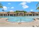 Stunning community pool with a zero entry point, surrounded by resort-style amenities and palm trees at 2487 Empress Dr, Kissimmee, FL 34741