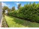 Well-maintained backyard featuring manicured lawn, lush hedges, and serene landscaping, perfect for outdoor enjoyment at 2503 Yellow Brick Rd, St Cloud, FL 34772