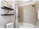 Close up on a bathroom with floating shelves and a shower-tub combination at 2503 Yellow Brick Rd, St Cloud, FL 34772