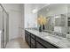 Bathroom with granite countertops, dual sinks, and a glass-enclosed shower for a modern and clean look at 2503 Yellow Brick Rd, St Cloud, FL 34772