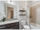 Bathroom featuring a granite vanity, floating shelves, and a shower-tub combination at 2503 Yellow Brick Rd, St Cloud, FL 34772