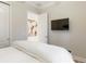 Bright bedroom with a mounted TV and view into the next room at 2503 Yellow Brick Rd, St Cloud, FL 34772
