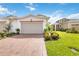 Charming villa featuring a red brick driveway and lush landscaping at 2503 Yellow Brick Rd, St Cloud, FL 34772