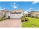 Charming villa featuring a red brick driveway and lush landscaping at 2503 Yellow Brick Rd, St Cloud, FL 34772