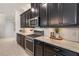 Modern kitchen with stainless steel KitchenAid gas range and microwave, granite countertop and dark cabinetry at 2503 Yellow Brick Rd, St Cloud, FL 34772