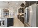 Modern kitchen featuring stainless steel appliances, dark cabinetry, and a large island with pendant lighting at 2503 Yellow Brick Rd, St Cloud, FL 34772