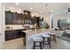Modern kitchen featuring an island with bar seating, stainless appliances, and dark cabinets at 2503 Yellow Brick Rd, St Cloud, FL 34772