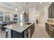 Open concept kitchen with large island, granite countertops, stainless steel appliances, and adjacent dining area at 2503 Yellow Brick Rd, St Cloud, FL 34772