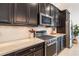 Stainless steel KitchenAid gas range with granite countertop and dark cabinetry in modern kitchen at 2503 Yellow Brick Rd, St Cloud, FL 34772