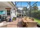 Spacious screened patio with brick flooring, outdoor dining, and a built-in bar, perfect for entertaining guests at 2503 Yellow Brick Rd, St Cloud, FL 34772