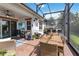 Expansive screened patio with brick flooring, comfortable seating, outdoor bar, and dining area for enjoying outdoor living at 2503 Yellow Brick Rd, St Cloud, FL 34772